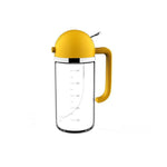 Doba 2-in-1 oil and gravy dispenser with clear body and yellow lid for easy pouring