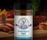 Uncle Clarence BBQ rub for righteous ribs in a container with herbs and cooked ribs in the background