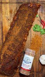 Uncle Clarence spice set featuring Righteous Ribs with a Kick seasoning next to a seasoned rack of ribs